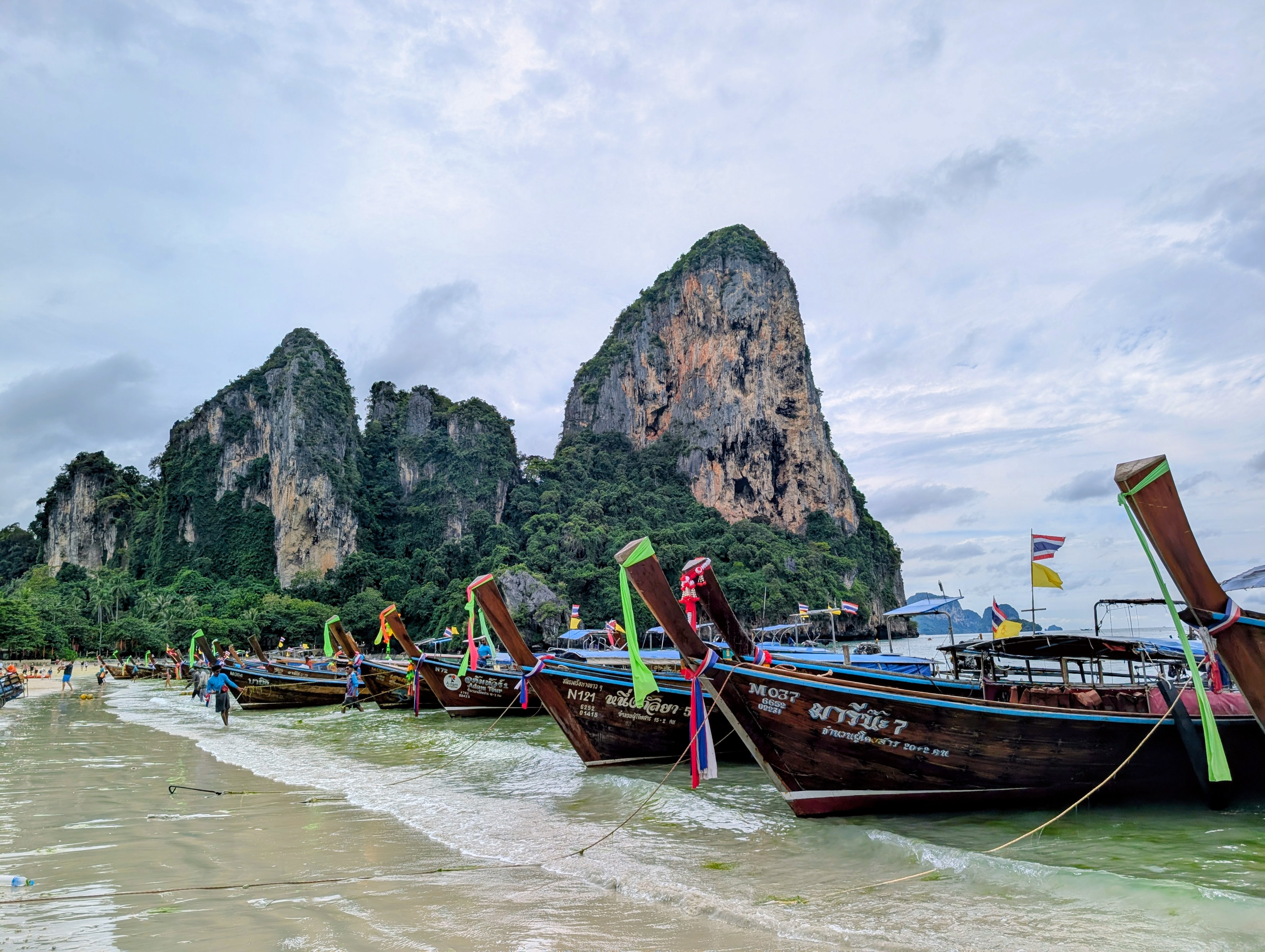 Long-tail boats lined up along Railay Beach