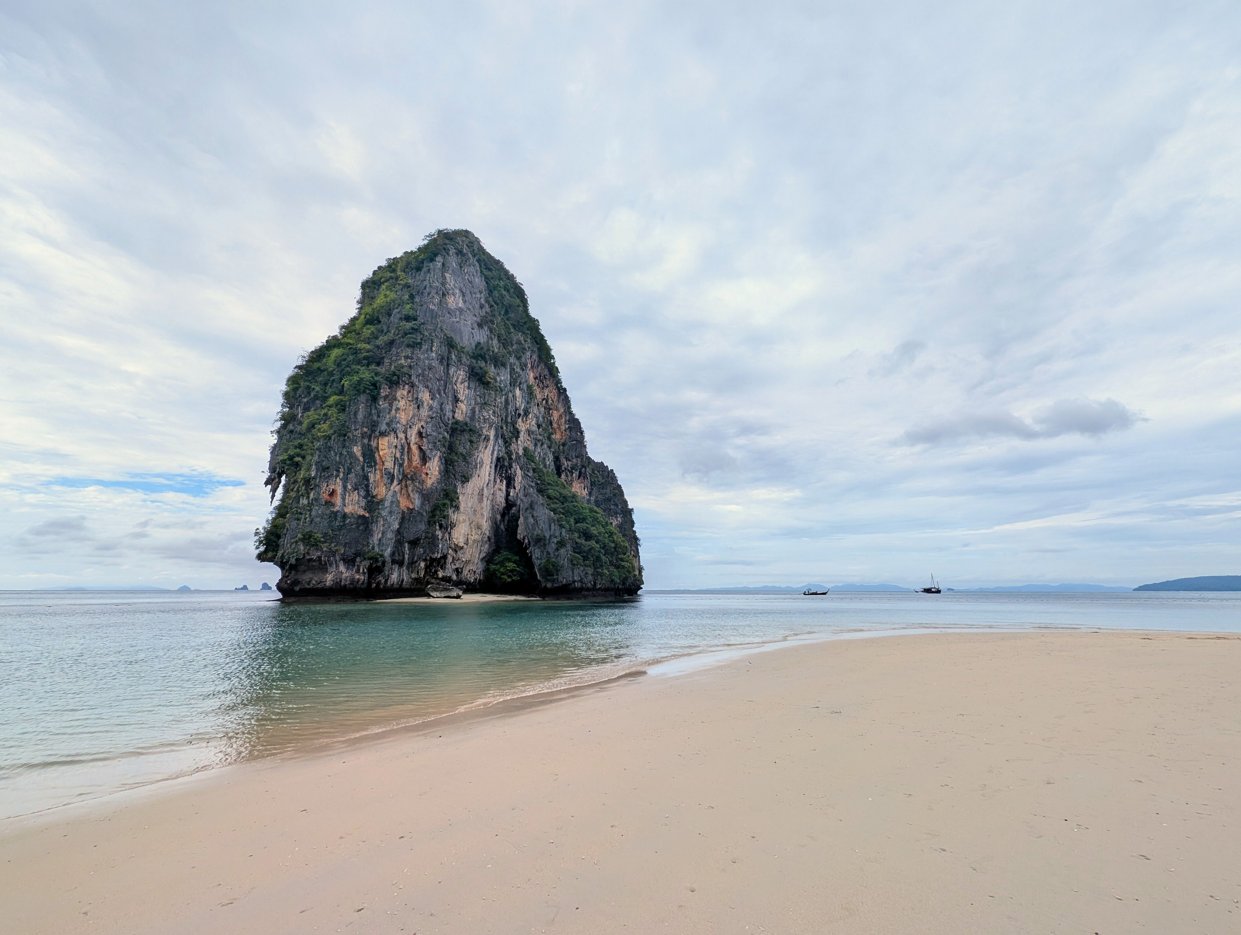 A solitary limestone karst standing in calm water